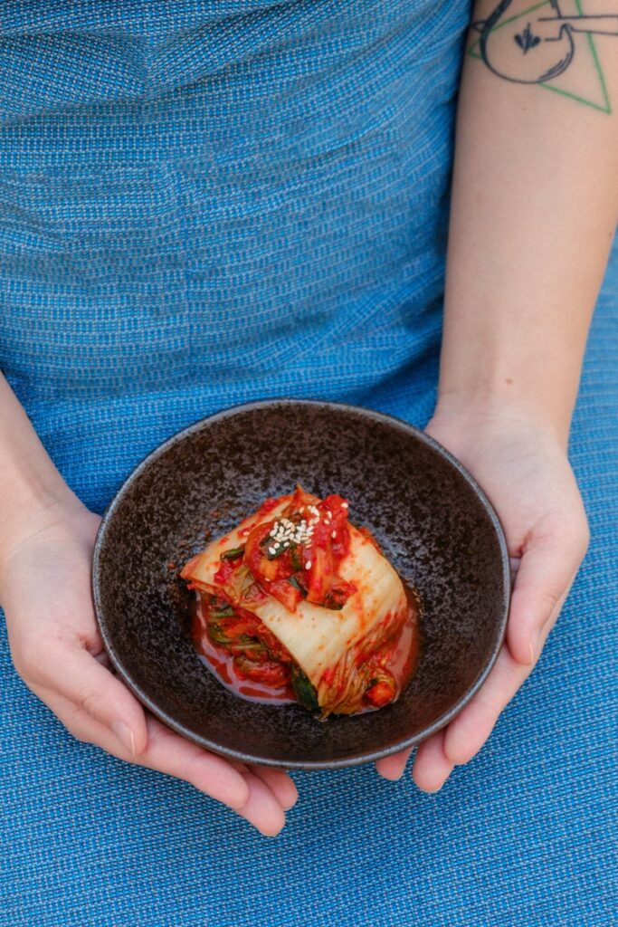kimchi in a black ceramic bowl