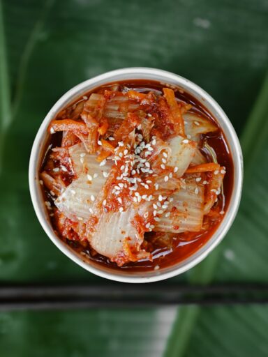 a bowl of food with chopsticks on a table